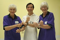 Dr Paul Lam in tai chi pose with fellow instructors