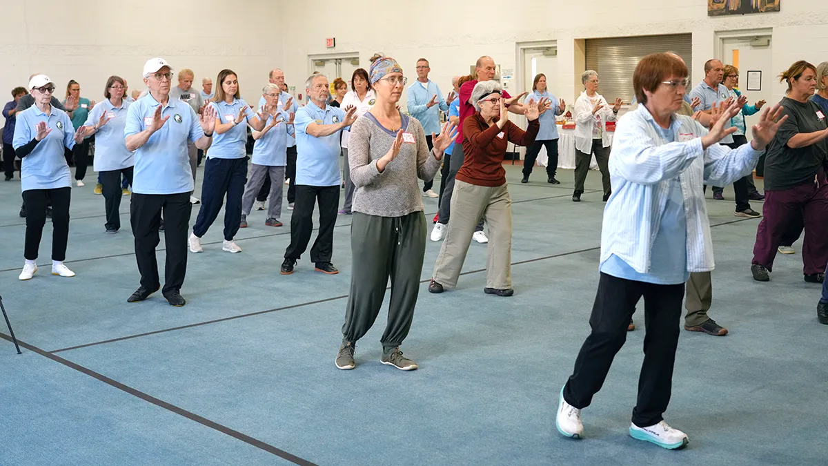 Participants practising Tai Chi Walking at a Tai Chi for Health workshop by Dr Paul Lam
